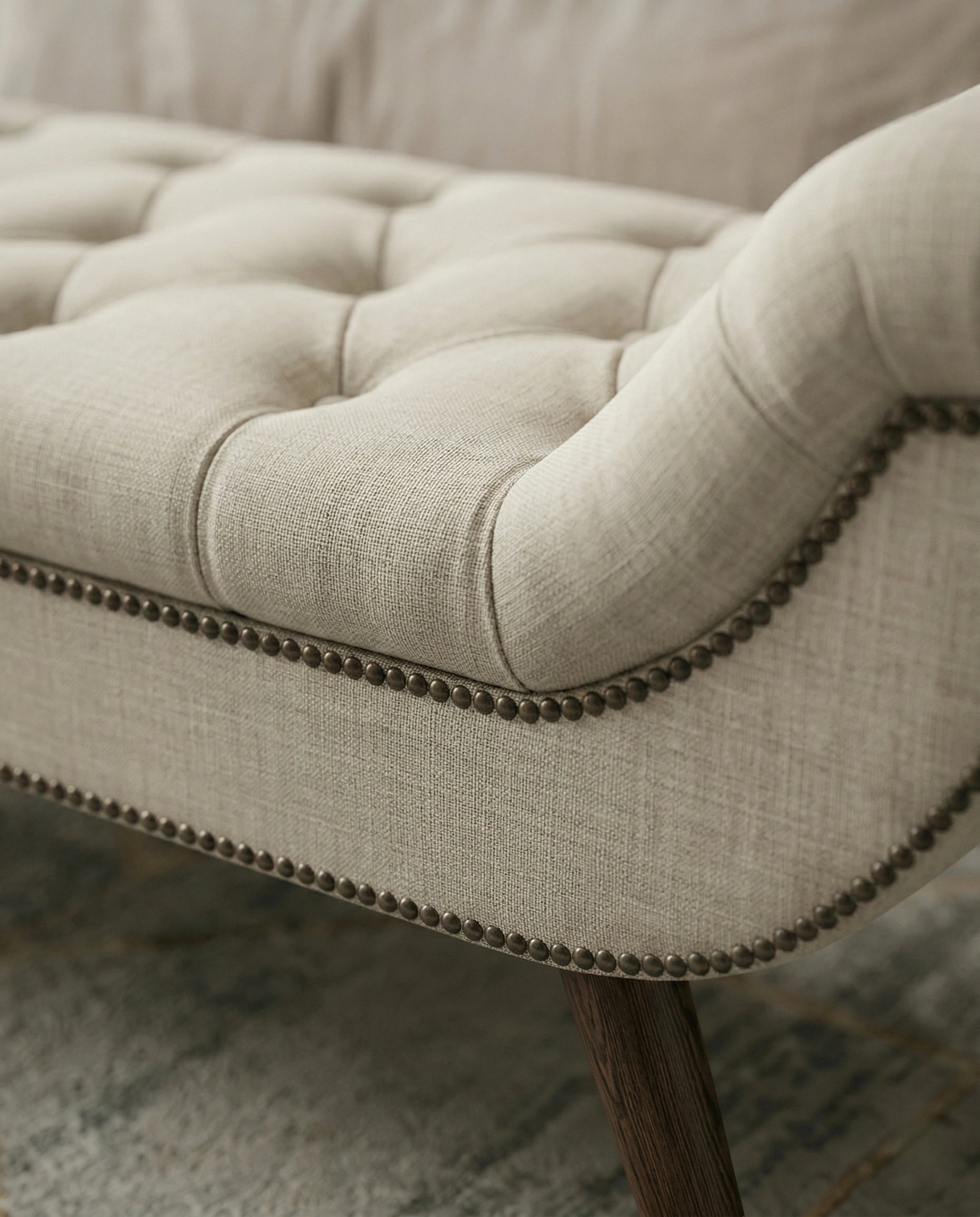 High-end foot of bed bench and premium beige tufted bed end bench crafted by Arris Concepts Luxury Pvt. Ltd.