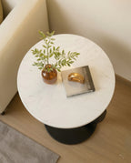 Modern stone side table and a black marble curved pedestal corner table by Arris Concepts Luxury Pvt. Ltd.