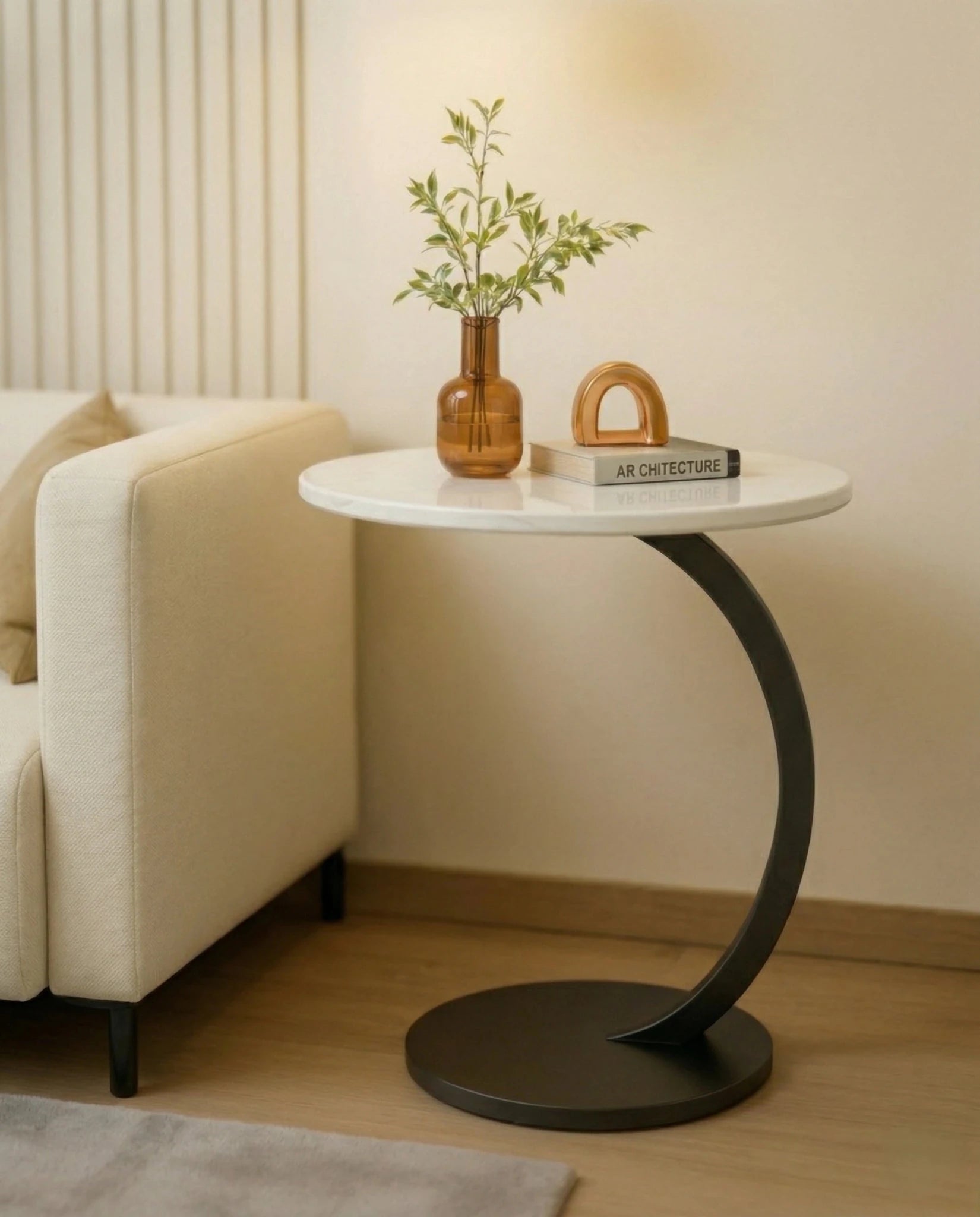 Modern stone side table and a black marble curved pedestal corner table by Arris Concepts Luxury Pvt. Ltd.