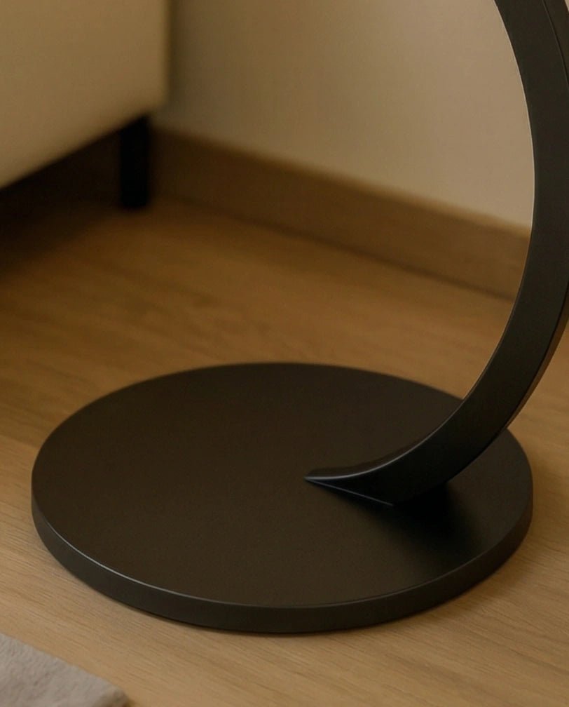 Modern stone side table and a black marble curved pedestal corner table by Arris Concepts Luxury Pvt. Ltd.