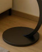 Modern stone side table and a black marble curved pedestal corner table by Arris Concepts Luxury Pvt. Ltd.