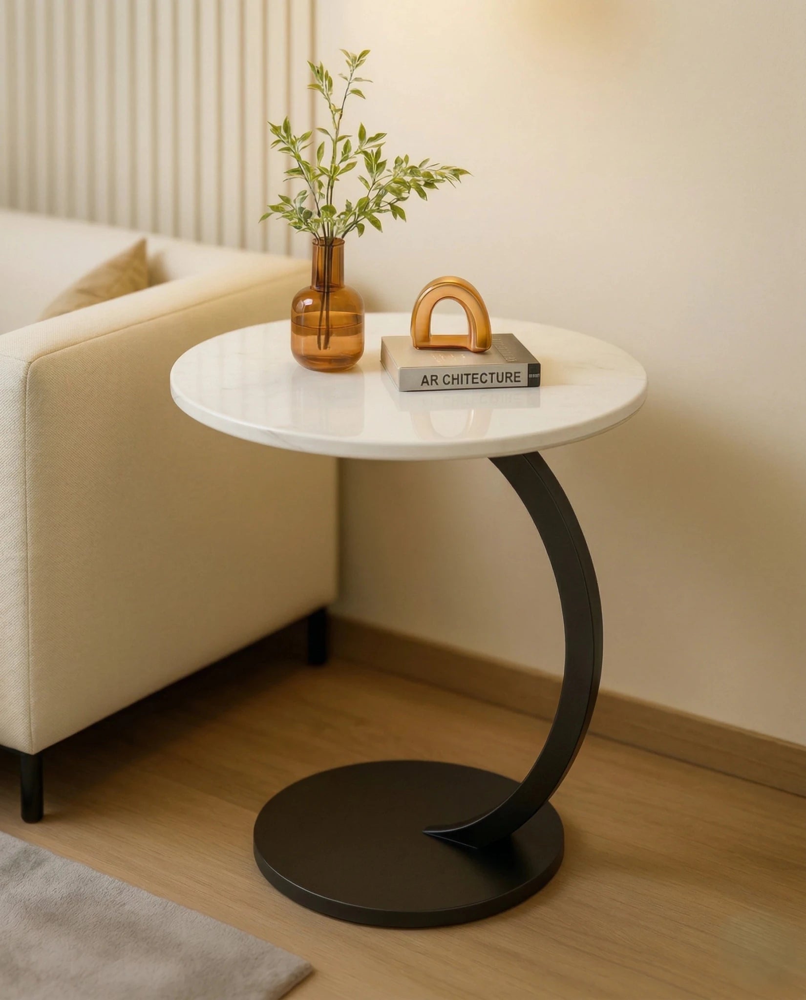 Modern stone side table and a black marble curved pedestal corner table by Arris Concepts Luxury Pvt. Ltd.