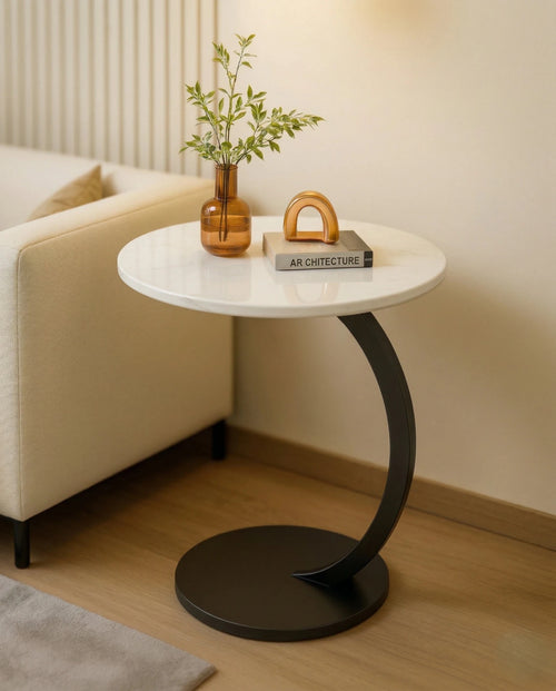 Modern stone side table and a black marble curved pedestal corner table by Arris Concepts Luxury Pvt. Ltd.