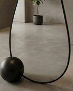 A premium asymmetrical black floor mirror with a modern irregular frame by Arris Concepts Luxury Pvt. Ltd.