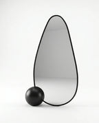 A premium asymmetrical black floor mirror with a modern irregular frame by Arris Concepts Luxury Pvt. Ltd.