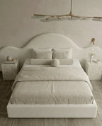 Designer upholstered floating bed and premium cream boucle platform bed by Arris Concepts Luxury Pvt. Ltd.
