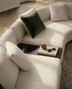 Beautiful premium curved boucle sofa with wood table crafted by Arris Concepts Luxury Pvt. Ltd.