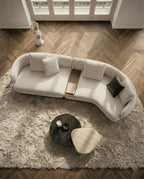 Beautiful premium curved boucle sofa with wood table crafted by Arris Concepts Luxury Pvt. Ltd.