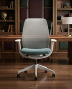 Modern desk chair with teal seat and premium ergonomic mesh office chair by Arris Concepts Luxury Pvt. Ltd.