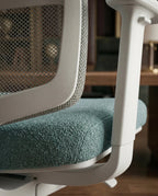 Modern desk chair with teal seat and premium ergonomic mesh office chair by Arris Concepts Luxury Pvt. Ltd.