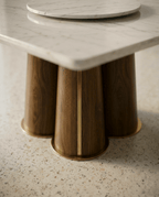 Beautiful premium square marble dining table with wood pedestal crafted by Arris Concepts Luxury Pvt. Ltd.