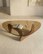 A premium tinted glass coffee table with a modern mid century center table base by Arris Concepts Luxury Pvt. Ltd.