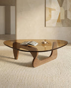 A premium tinted glass coffee table with a modern mid century center table base by Arris Concepts Luxury Pvt. Ltd.
