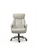A white tufted executive desk chair and designer white home office seating by Arris Concepts Luxury Pvt. Ltd.